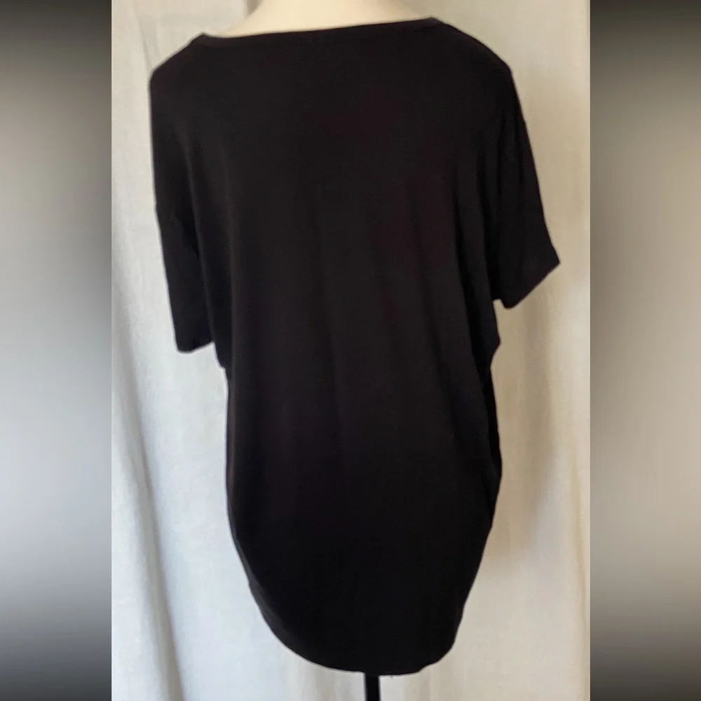 Black short sleeve tee shirt with front pocket covered with silver studs